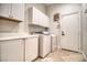 Well-equipped laundry room featuring a modern washer and dryer plus ample cabinet storage at 129 Chateau Whistler Ct, Las Vegas, NV 89148