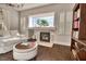 Cozy living room with a marble fireplace and shutters bringing warmth and character to the space at 129 Chateau Whistler Ct, Las Vegas, NV 89148