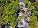 Aerial view of a circular water fountain among lush tropical trees, surrounded by winding roads and mature foliage at 1309 Reisling Ct, Las Vegas, NV 89144