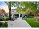 Backyard features patio, lush lawn, mature trees, and stone accents, perfect for outdoor entertaining at 1309 Reisling Ct, Las Vegas, NV 89144