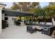 Spacious backyard with outdoor kitchen, seating area, and a modern fire pit at 1309 Reisling Ct, Las Vegas, NV 89144