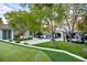 Lush backyard featuring a putting green, pool, multiple seating areas and expansive lawn at 1309 Reisling Ct, Las Vegas, NV 89144