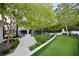 Backyard showcases a manicured lawn, paved patio, outdoor seating, putting green, and lush landscaping at 1309 Reisling Ct, Las Vegas, NV 89144