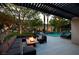 Luxurious backyard patio with a cozy lounge area, modern fire pit, and a sparkling pool, perfect for outdoor entertaining at 1309 Reisling Ct, Las Vegas, NV 89144