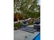 View of backyard featuring raised stone patio steps and manicured landscaping at 1309 Reisling Ct, Las Vegas, NV 89144