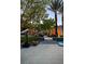 Beautiful backyard with stone patio, palm trees, and a glimpse of the sparkling pool for upscale outdoor living at 1309 Reisling Ct, Las Vegas, NV 89144