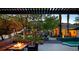 Outdoor living area with a fire pit, comfy seating, manicured landscaping, and inviting backyard at 1309 Reisling Ct, Las Vegas, NV 89144