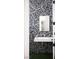 Striking powder room featuring trendy terrazzo tile and floating sink at 1309 Reisling Ct, Las Vegas, NV 89144
