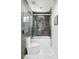 Bathroom with gray tile, marble floors, shower with glass enclosure, and modern fixtures at 1309 Reisling Ct, Las Vegas, NV 89144