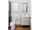 Bathroom with wood flooring, white cabinets, and a tiled shower behind a glass partition at 1309 Reisling Ct, Las Vegas, NV 89144