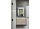 Modern bathroom with a floating wood vanity, sleek mirror, and gray stone tile at 1309 Reisling Ct, Las Vegas, NV 89144