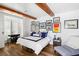 Cozy bedroom featuring hardwood floors, beamed ceiling, and bright, natural lighting at 1309 Reisling Ct, Las Vegas, NV 89144