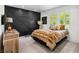 Stylish bedroom featuring a geometric wood accent wall and bright windows with green views at 1309 Reisling Ct, Las Vegas, NV 89144