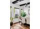 Bright dining room with natural light, black ceiling beams and modern lighting fixture at 1309 Reisling Ct, Las Vegas, NV 89144
