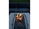 Close-up view of a modern, glass-encased outdoor fire pit with a gray stone base at 1309 Reisling Ct, Las Vegas, NV 89144