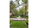 Charming fountain surrounded by colorful flowers and lush greenery creates an inviting outdoor oasis at 1309 Reisling Ct, Las Vegas, NV 89144