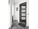 Stylish front door with a modern design, complemented by elegant sconces and a welcoming entrance mat at 1309 Reisling Ct, Las Vegas, NV 89144