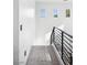 Bright hallway featuring a modern metal railing and three windows for ample natural light at 1309 Reisling Ct, Las Vegas, NV 89144
