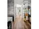 Bright hallway featuring light hardwood floors and glass-enclosed wine cellar at 1309 Reisling Ct, Las Vegas, NV 89144