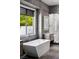 Stylish bathroom featuring a soaking tub, modern vanity, and glass-enclosed shower at 1309 Reisling Ct, Las Vegas, NV 89144