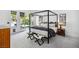 Modern main bedroom featuring a four-poster bed and access to a backyard patio at 1309 Reisling Ct, Las Vegas, NV 89144
