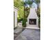Backyard featuring a modern outdoor fireplace, stone tile and manicured landscaping at 1309 Reisling Ct, Las Vegas, NV 89144