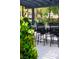 Patio featuring tiled floors, an outdoor table with chairs, and tasteful landscaping at 1309 Reisling Ct, Las Vegas, NV 89144