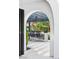 View of a patio with tiled floors and an outdoor table with bar stools, seen through an archway at 1309 Reisling Ct, Las Vegas, NV 89144