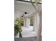 Covered patio featuring bright white walls, tile flooring, and decorative outdoor ceiling fans at 1309 Reisling Ct, Las Vegas, NV 89144