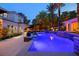 Inviting outdoor space with a sparkling blue pool, palm trees, and a luxury home with an outdoor seating area at 1309 Reisling Ct, Las Vegas, NV 89144