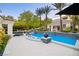 Stunning pool area with lounge chairs, tropical plants, and elegant design create a backyard oasis at 1309 Reisling Ct, Las Vegas, NV 89144