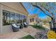 Charming backyard patio with seating area, lush greenery, and large windows at 1372 Couperin Dr, Henderson, NV 89052