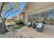 Backyard featuring stone patio, outdoor seating, and beautifully landscaped greenery at 1372 Couperin Dr, Henderson, NV 89052