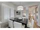 Elegant dining room features plantation shutters, a modern light fixture and an open floor plan at 1372 Couperin Dr, Henderson, NV 89052