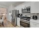 Open concept eat-in kitchen featuring stainless appliances and tile backsplash at 1372 Couperin Dr, Henderson, NV 89052