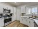 Well-lit kitchen features quartz countertops, stainless steel appliances and wood look flooring at 1372 Couperin Dr, Henderson, NV 89052