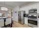 Open concept eat-in kitchen features stainless appliances and seating for six at 1372 Couperin Dr, Henderson, NV 89052