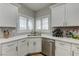 Bright kitchen featuring white cabinets, quartz countertops, and stainless steel appliances at 1372 Couperin Dr, Henderson, NV 89052