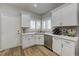 Bright kitchen featuring white cabinets, countertops, and stainless steel appliances at 1372 Couperin Dr, Henderson, NV 89052