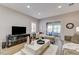 Inviting living room with hardwood floors, recessed lighting, a large tv and access to a sunroom at 1372 Couperin Dr, Henderson, NV 89052