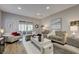 Relaxing living room with hardwood floors, recessed lighting, contemporary furniture and a sliding glass door at 1372 Couperin Dr, Henderson, NV 89052