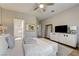 Bright main bedroom featuring a ceiling fan, TV, and ensuite bathroom at 1372 Couperin Dr, Henderson, NV 89052
