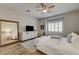 Bright main bedroom featuring a ceiling fan, window and large mirror at 1372 Couperin Dr, Henderson, NV 89052