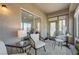 Relaxing sunroom features tile flooring, windows, patio access and comfortable wicker furniture at 1372 Couperin Dr, Henderson, NV 89052