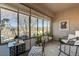 Bright sunroom featuring large windows, tiled floor, and cozy seating with backyard views at 1372 Couperin Dr, Henderson, NV 89052