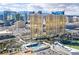 Stunning aerial view of the golden towers, resort pool, and surrounding Las Vegas cityscape against a beautiful sky at 145 E Harmon Ave # 3101, Las Vegas, NV 89109