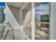 Open-air balcony featuring glass railing and sliding door, offering views of the city skyline at 145 E Harmon Ave # 3101, Las Vegas, NV 89109