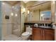 Modern bathroom featuring glass-enclosed shower, sleek vanity, and elegant mirror at 145 E Harmon Ave # 3101, Las Vegas, NV 89109