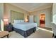 Relaxing bedroom with king bed, nightstand, and a view into the bathroom at 145 E Harmon Ave # 3101, Las Vegas, NV 89109