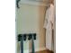 Hotel room closet with white robe and luggage rack provides convienent storage solutions at 145 E Harmon Ave # 3101, Las Vegas, NV 89109